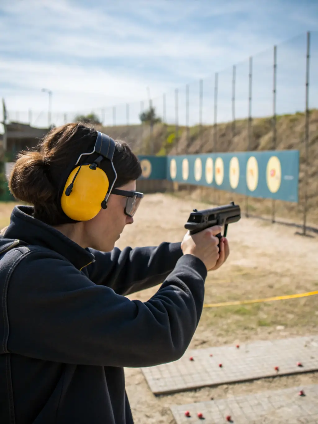 A focused image of a shooter aiming at a target, emphasizing the precision and concentration required in AASE's shooting program.